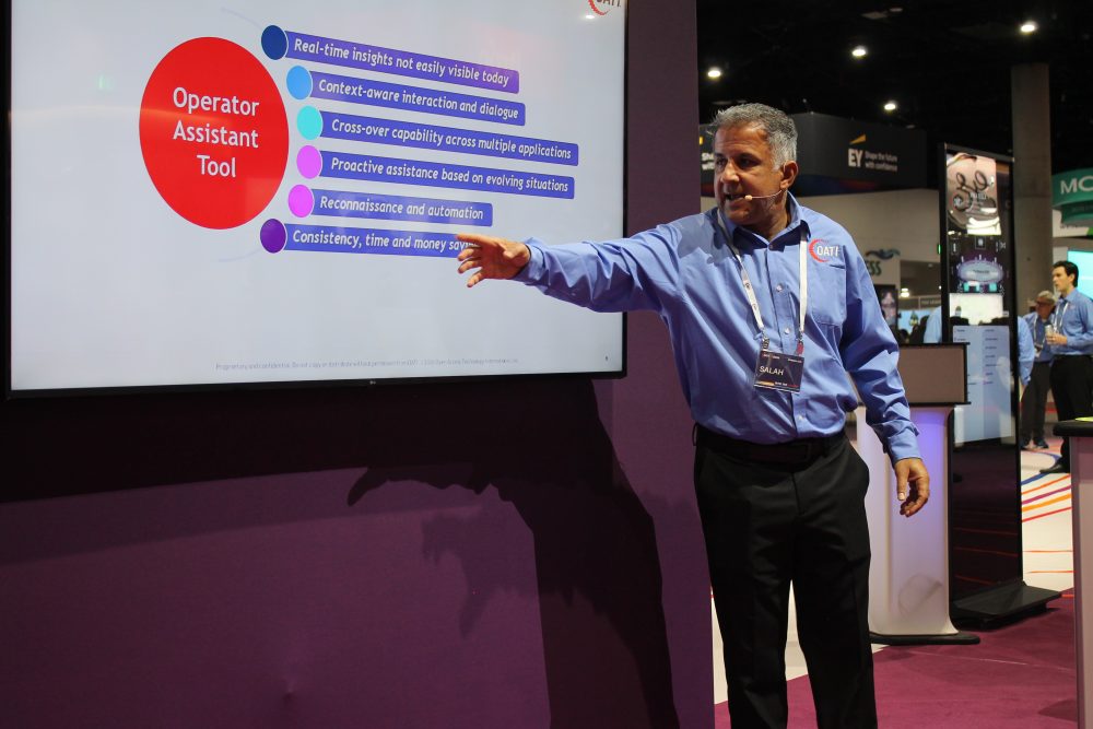 An OATI employee points at the OATI Operator Assistant tool during a demo at a trade show