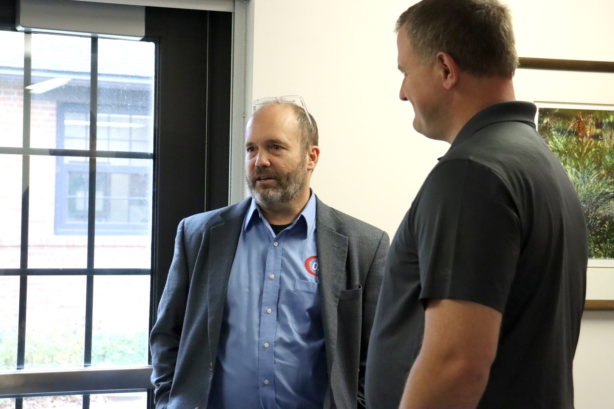 David Heim of OATI in conversation with a guest before the ceremony