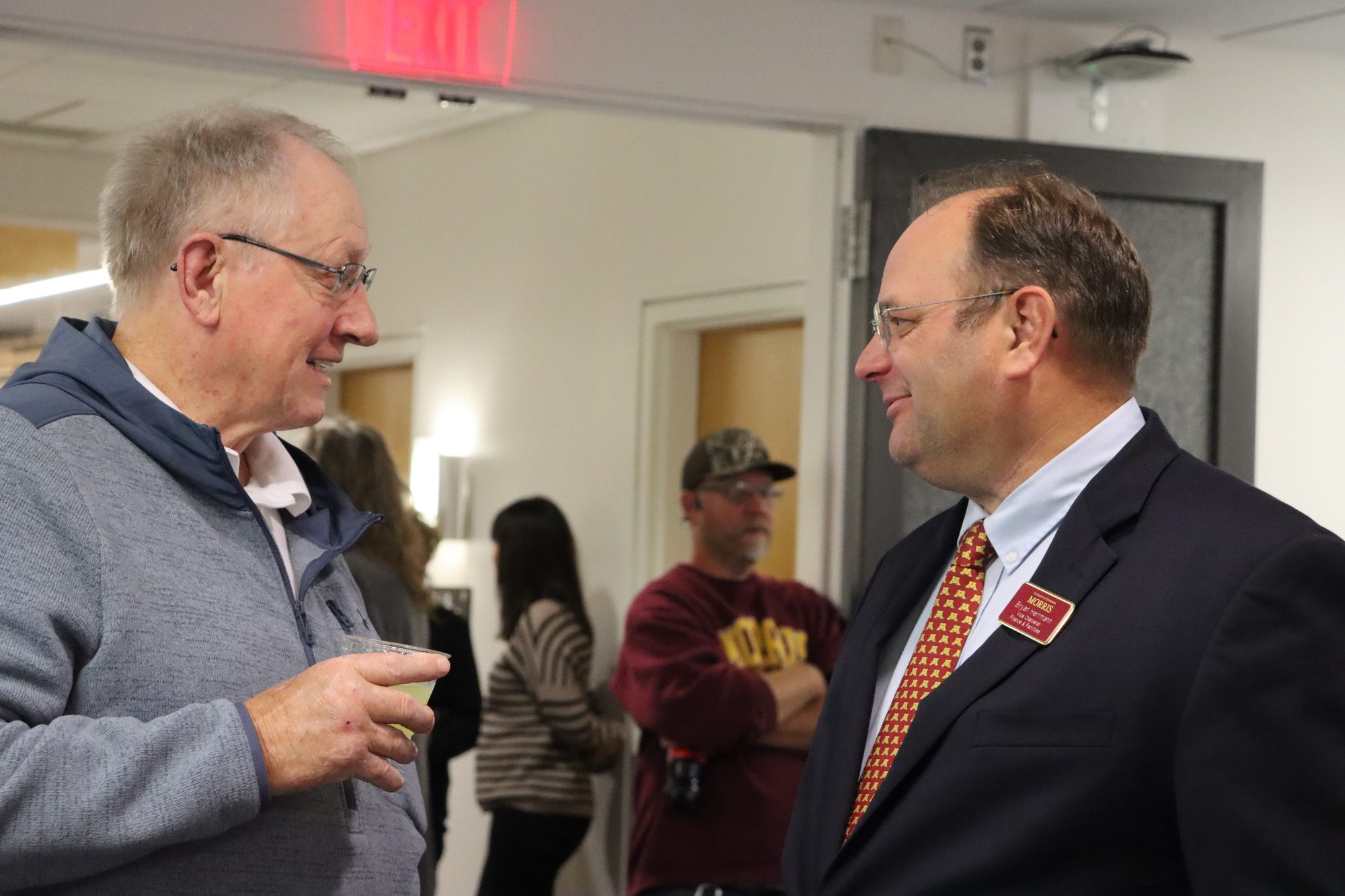 Bryan Herrmann of UMN Morris talks with a guest at the reception