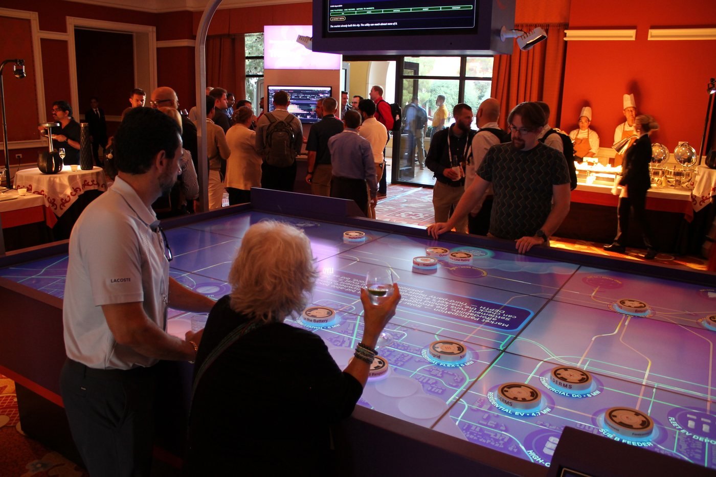 Attendees at the interactive touch table at the AI Learning Event