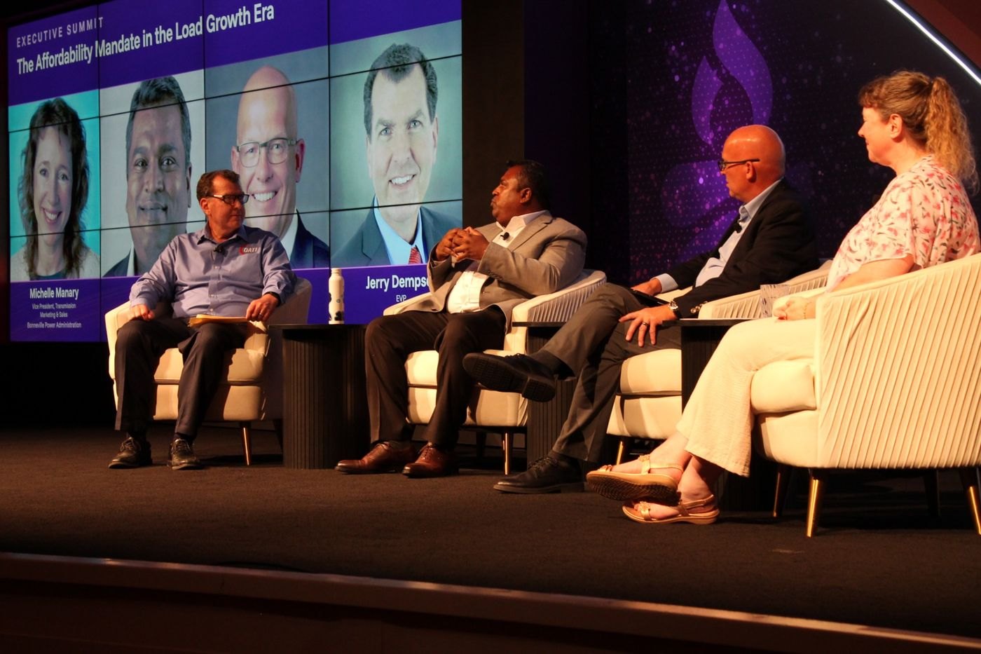 The Affordability Mandate panel and moderator on stage under the session title