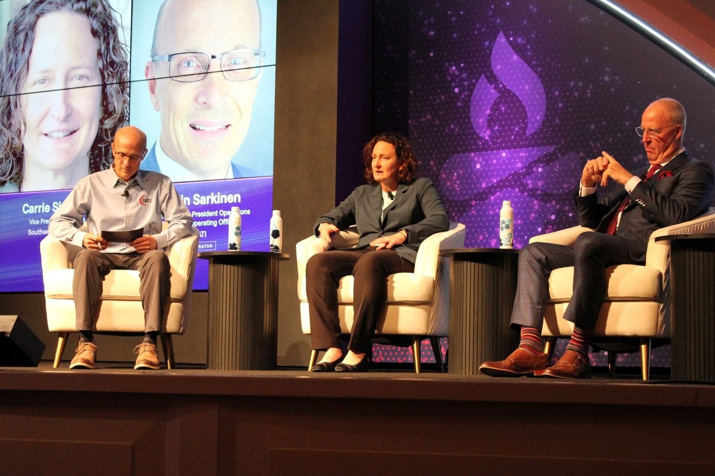 Carrie Simpson, John Bear and moderator Kevin Sarkinen on stage for the Market Movements panel